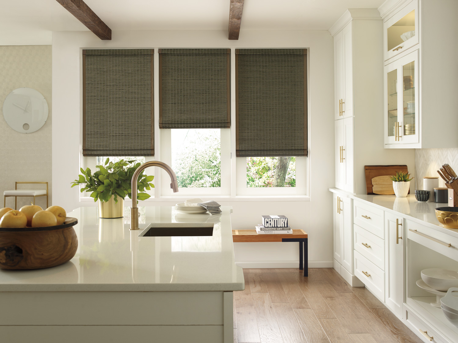 Modern kitchen design with white cabinets, window blinds, and NATURAL WOVEN WOOD ROMAN SHADES.