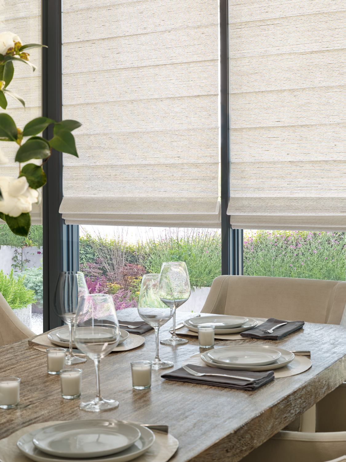 Dining room featuring Hunter Douglas Alustra® Woven Textures® Roman Shades.
