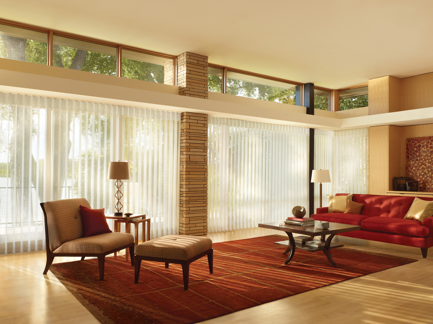 Contemporary living room featuring red furniture and Hunter Douglas Luminette® Sheer Panels on the windows.