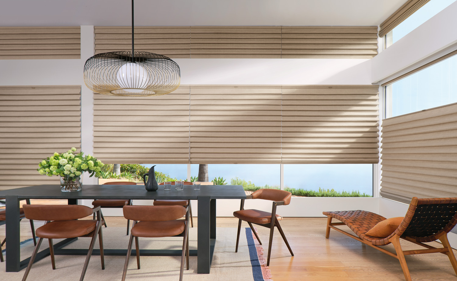 Dining room with table and chairs, featuring Hunter Douglas Vignette® Roman Shades.