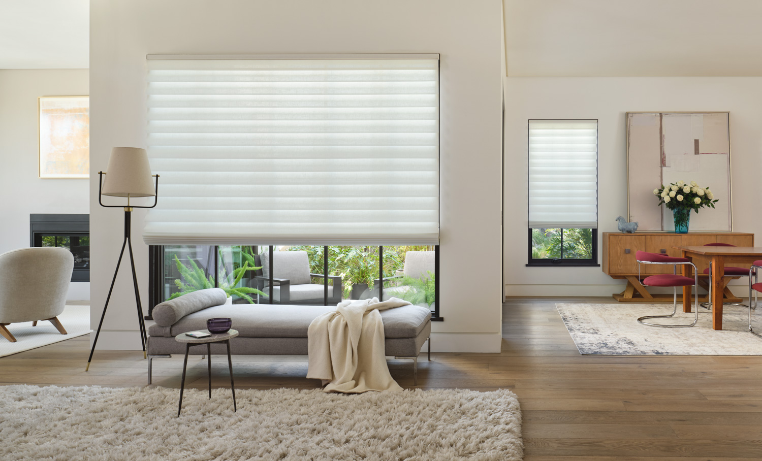 Living room with large window and couch, featuring Hunter Douglas Vignette® Roman Shades.
