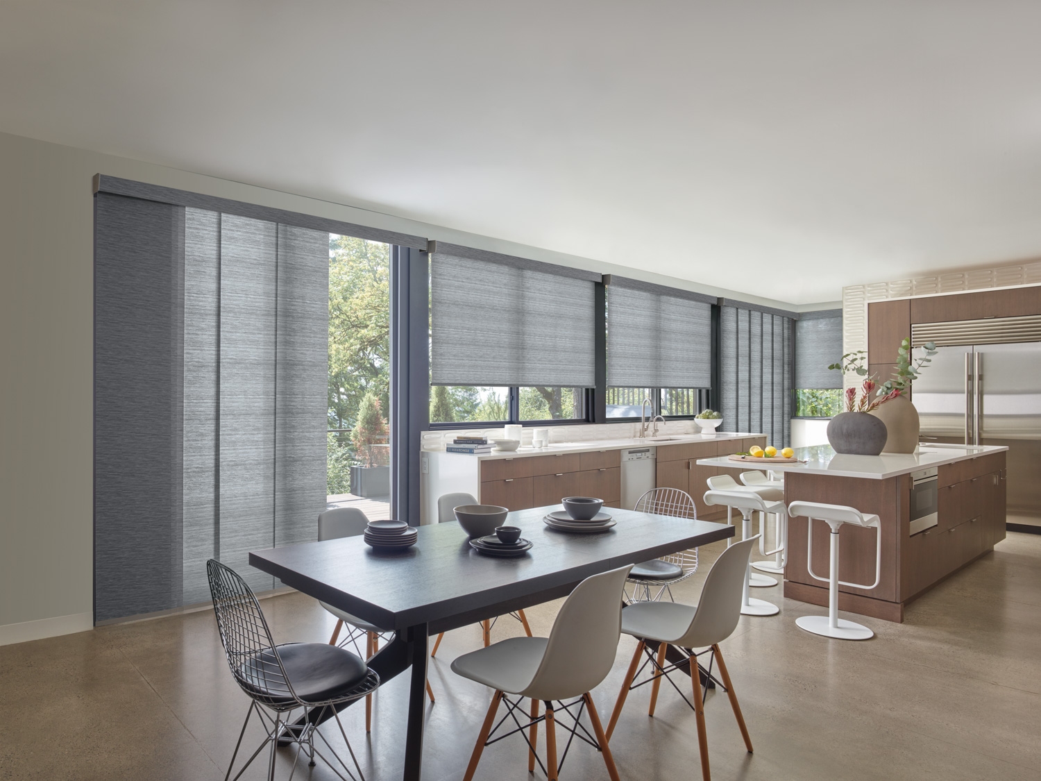 Dining area in kitchen with Hunter Douglas Designer Roller Shades.