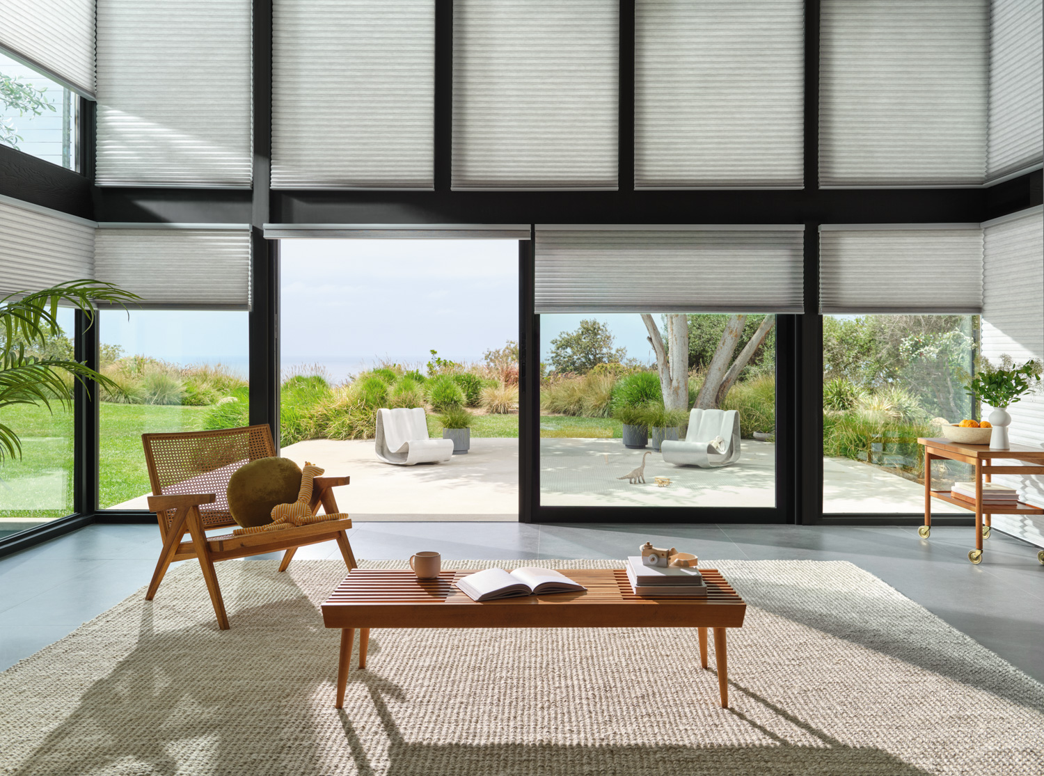 Living room with sliding glass doors and patio, featuring Hunter Douglas Duette® Cellular Shades.