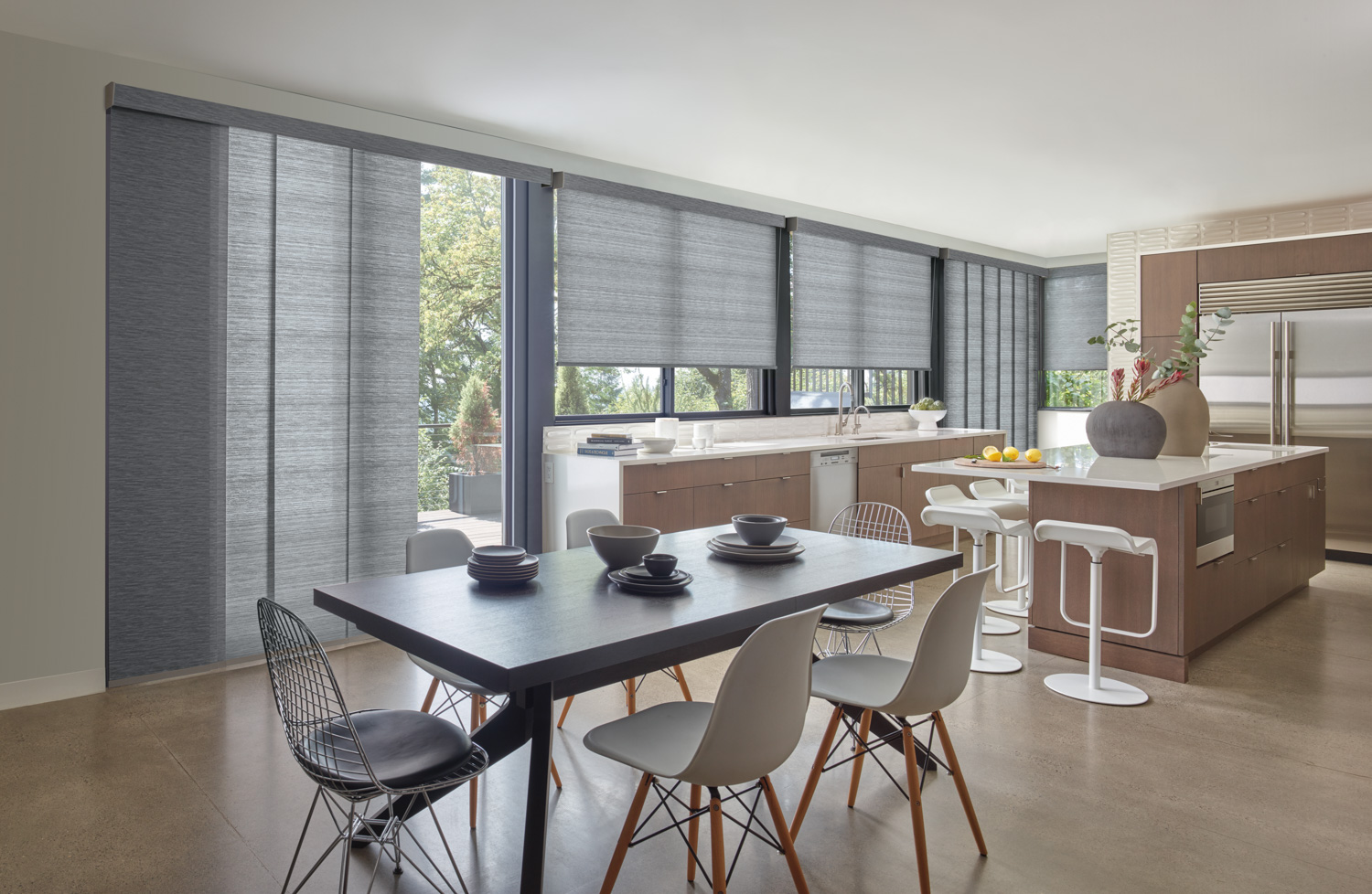 Dining area in kitchen with Hunter Douglas Designer Roller Shades.