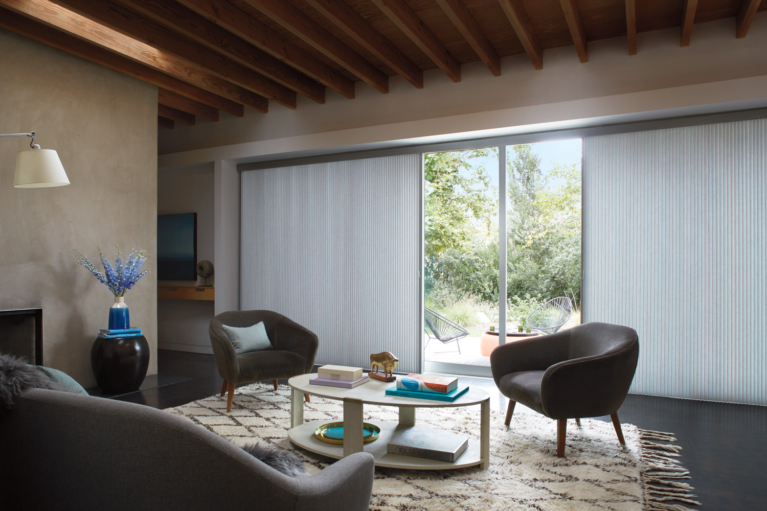 Spacious living room with a Hunter Douglas VERTIGLIDE™ on a large sliding glass door.