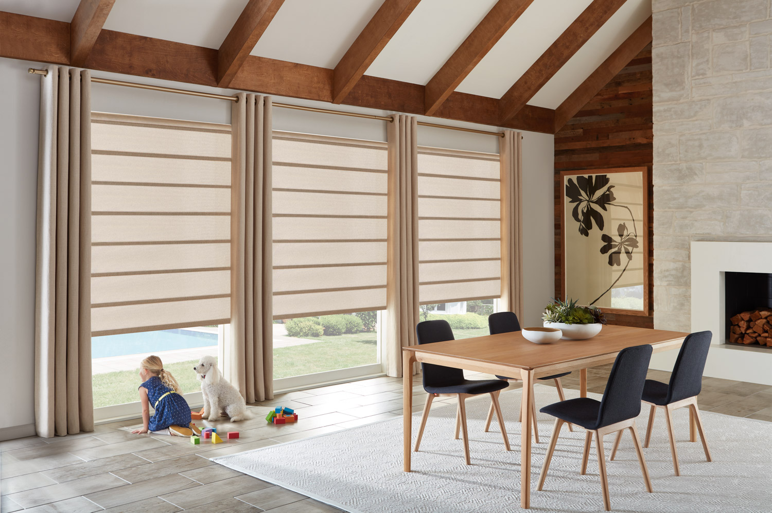 Dining room with table and chairs in front of window, featuring Hunter Douglas Alustra® Architectural Roller Shades for child and pet safety.
