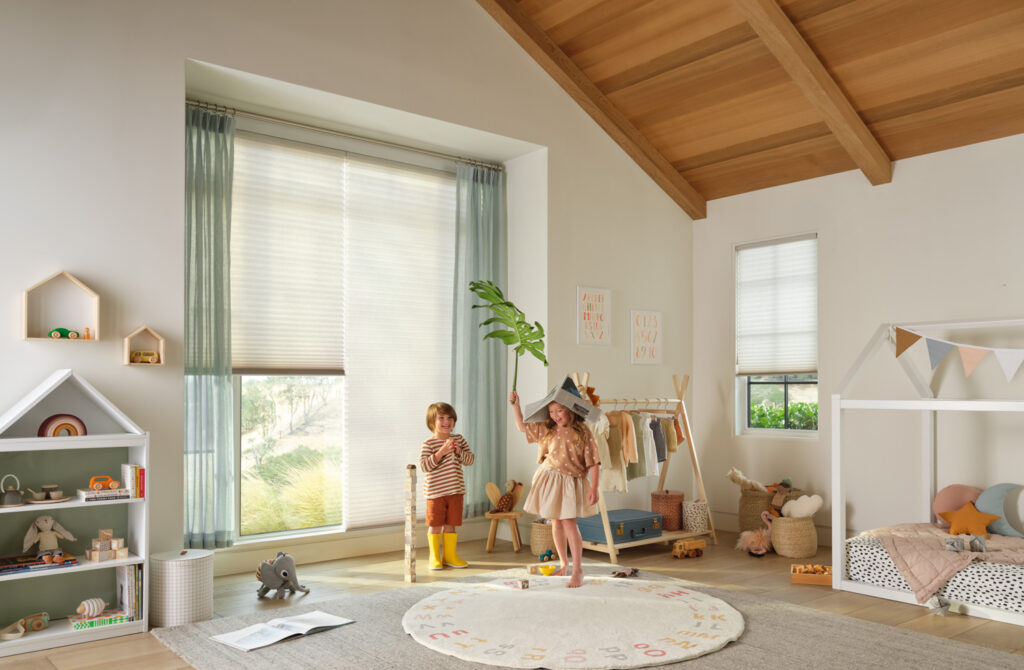 Cozy child's bedroom with wooden furniture and a white rug, complemented by Hunter Douglas Duette® Honeycomb Shades.