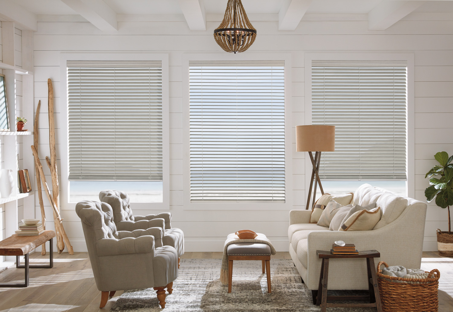 Living room with white walls, wooden floors, and Hunter Douglas Modern Precious Metals® Mini Blinds.