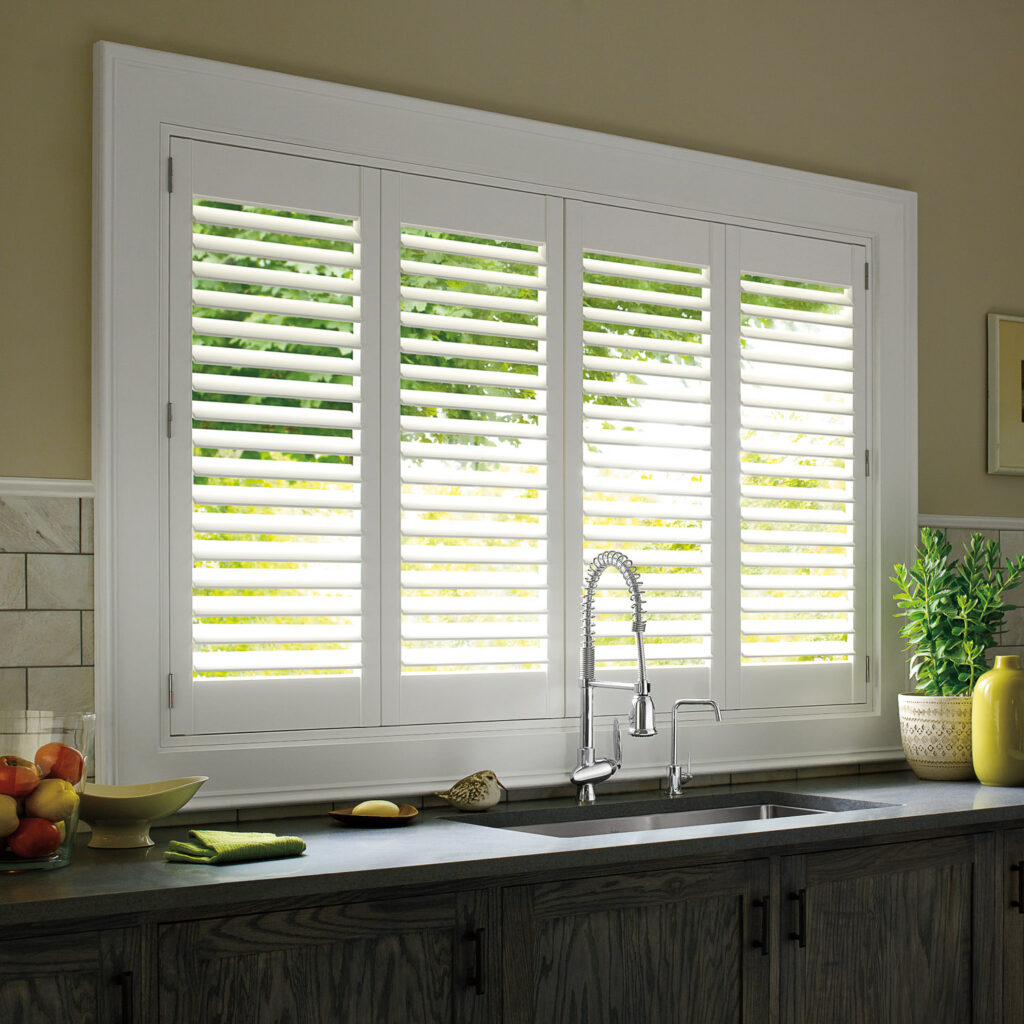 A kitchen with white composite shutters and a sink.