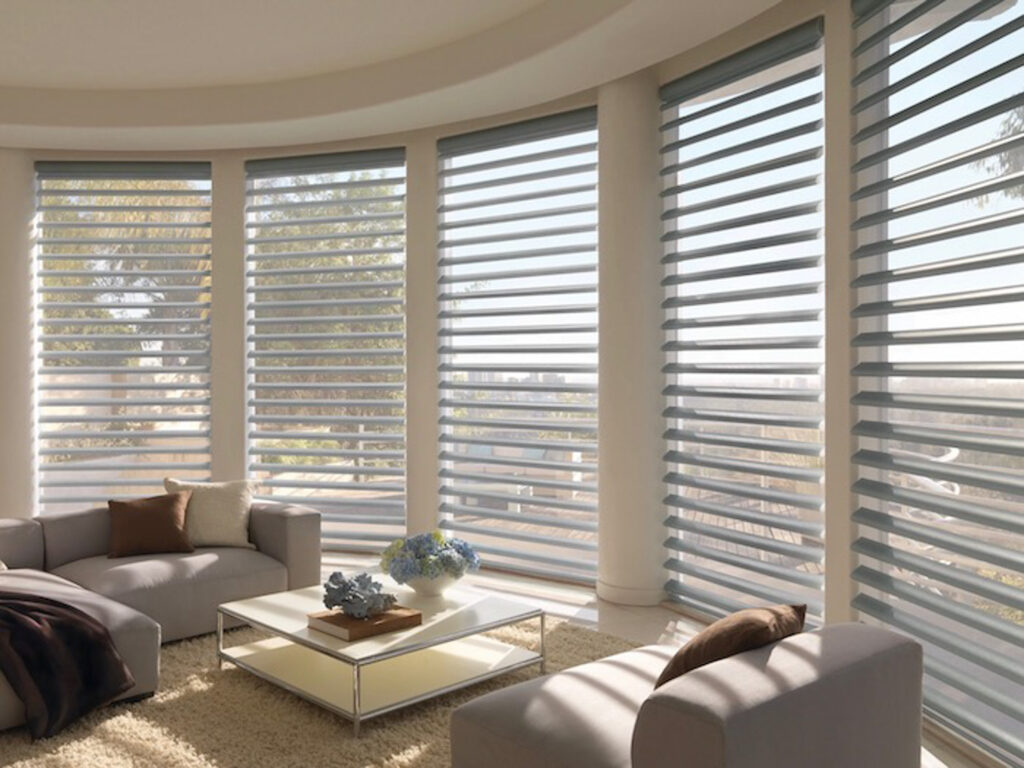 Living room with large windows and Hunter Douglas Pirouette® Window Shades.