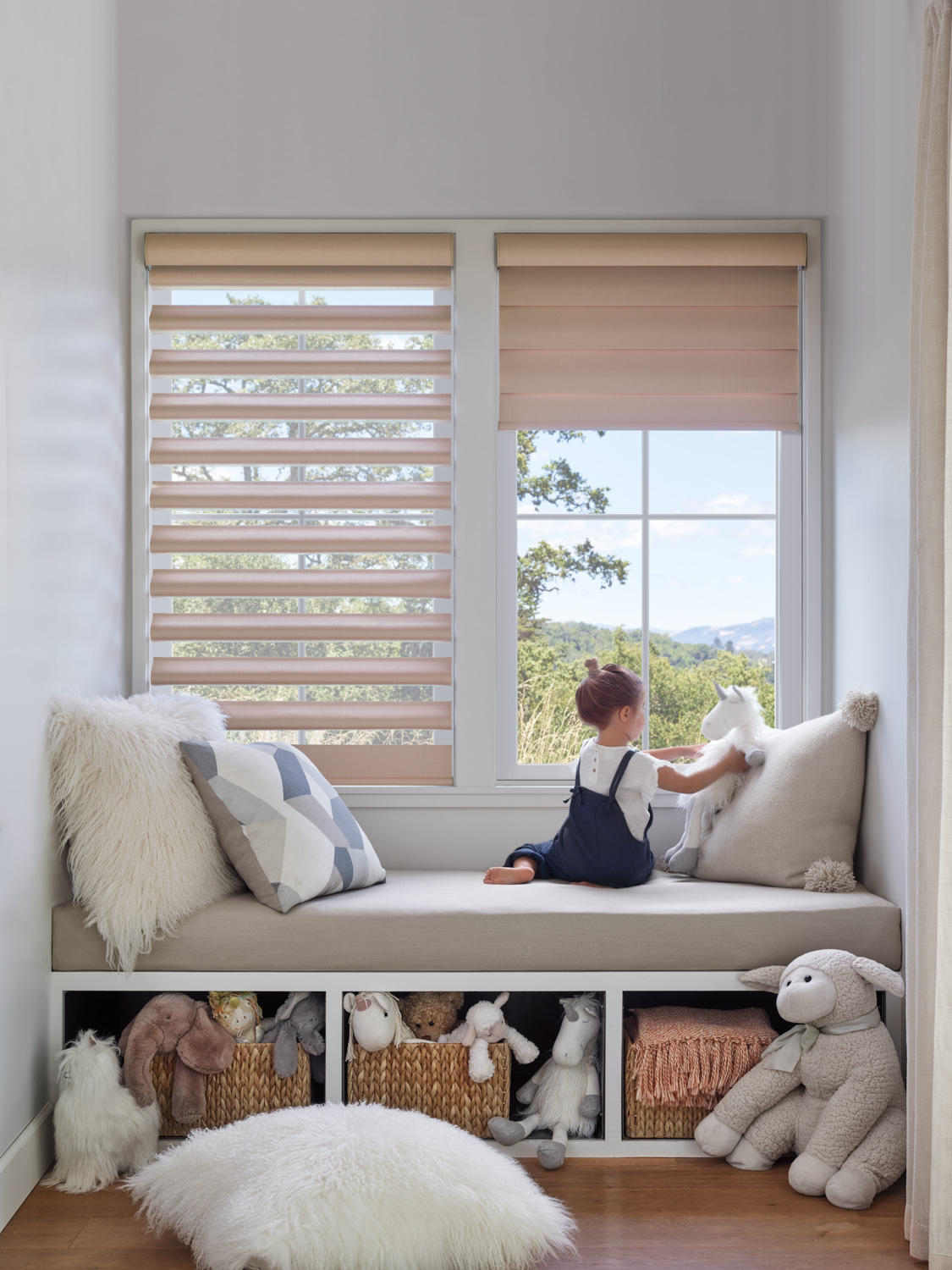 Kid sitting on window seat holding plush toy with Pirouette® Shades.