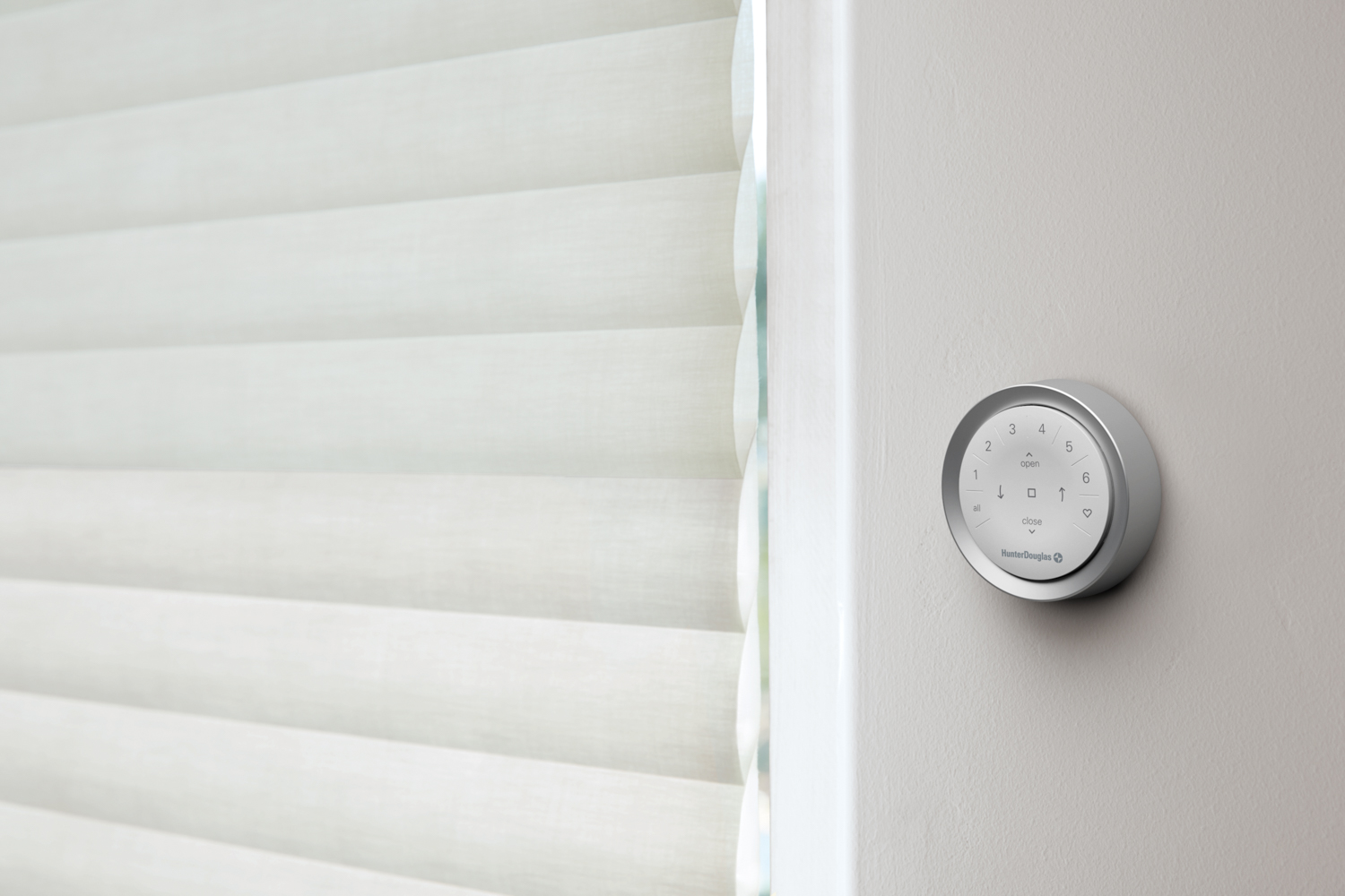 Hunter Douglas PowerView® Surface Remote mounted on a wall.
