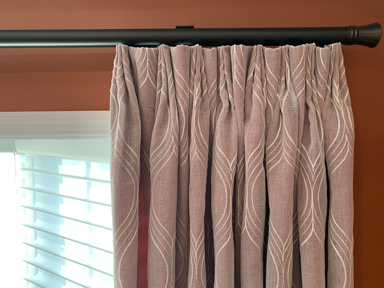 Sheer curtains with inverted pleat, allowing soft light to filter through the fabric.
